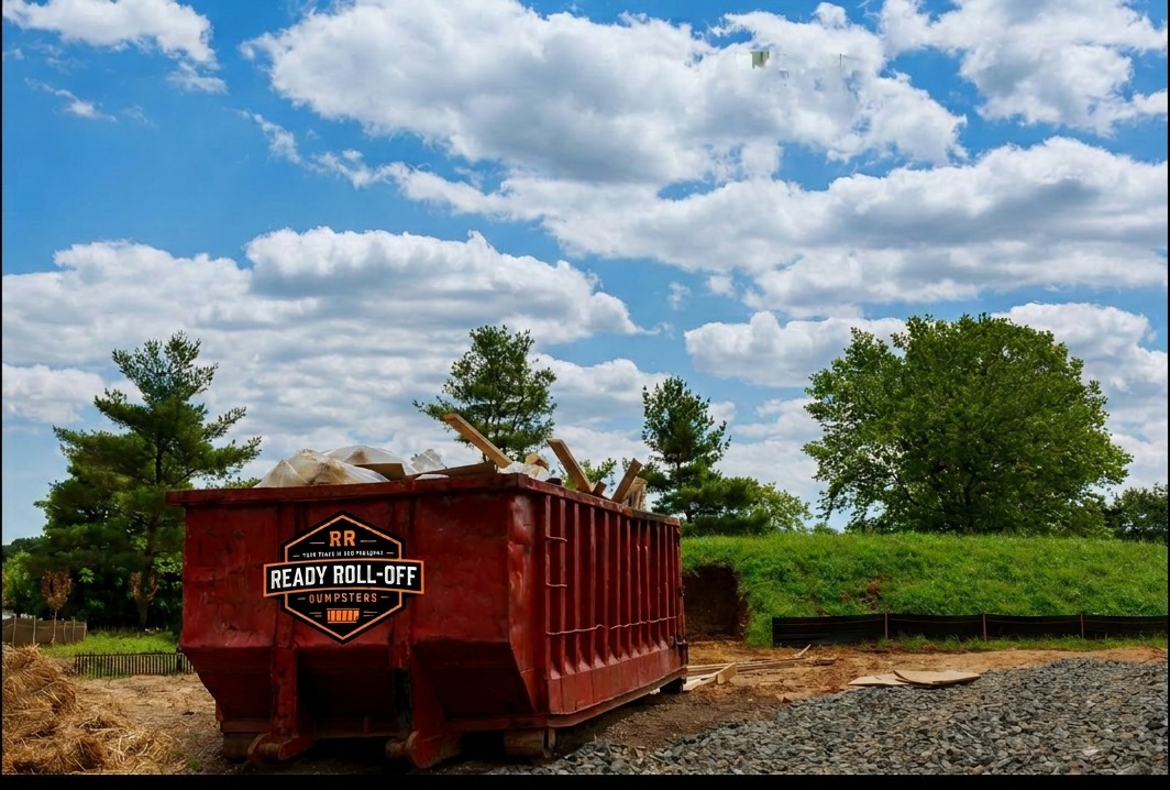 Orange roll-off dumpster filled with construction debris